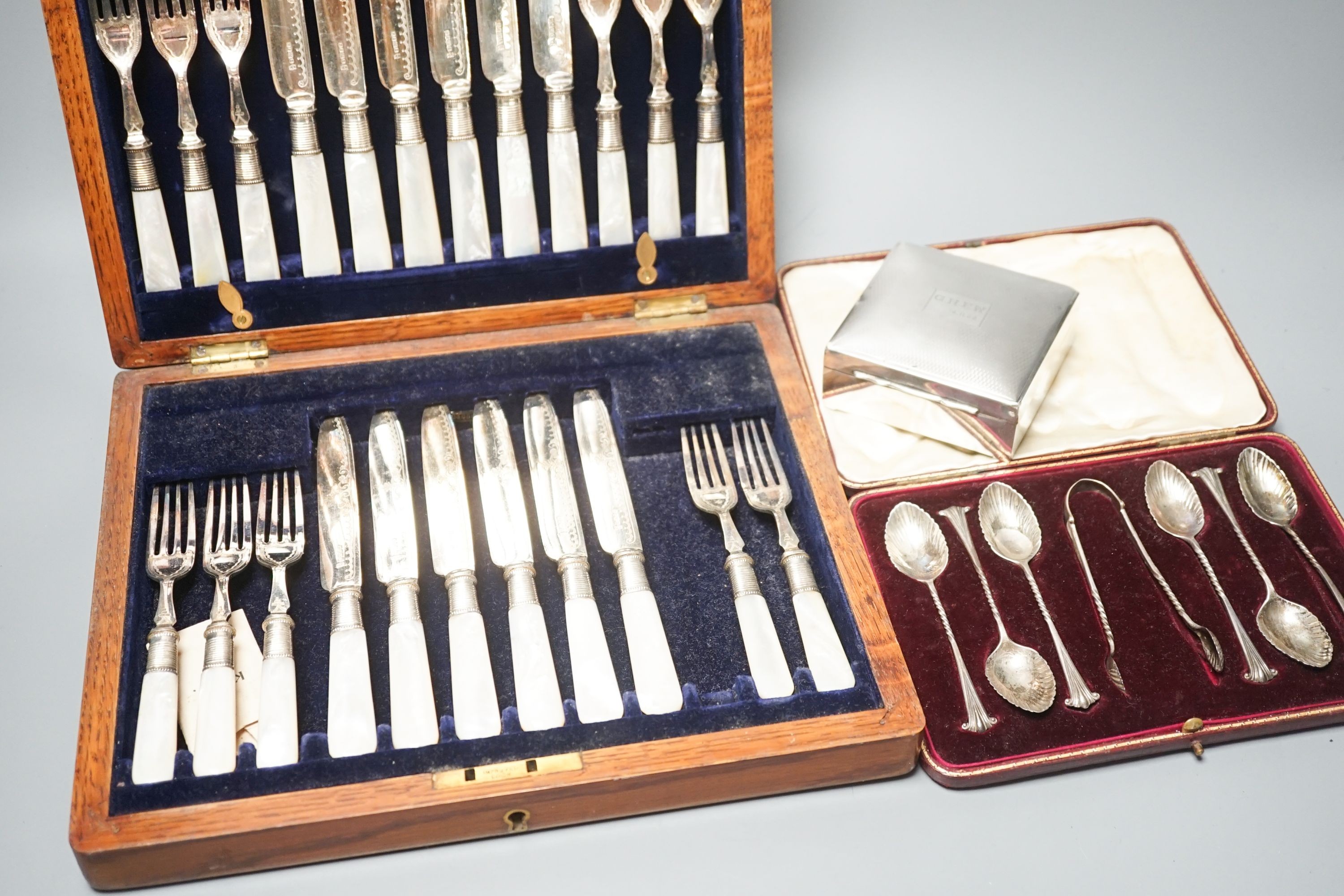 A cased set of silver teaspoons and tongs, a silver mounted cigarette case and plated part dessert service